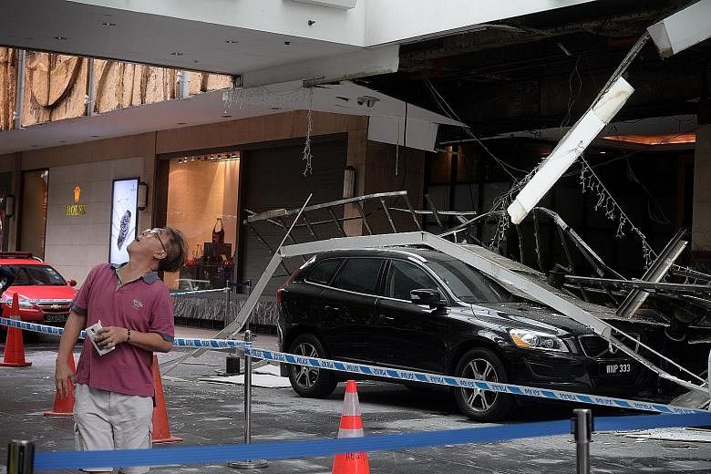 A black Volvo and a white Prime Royal taxi were caught under the roof of Hilton Singapore's driveway when it collapsed at close to 3pm yesterday. Four people were taken to hospital. Hilton regional general manager Peter Webster theorised that the pro