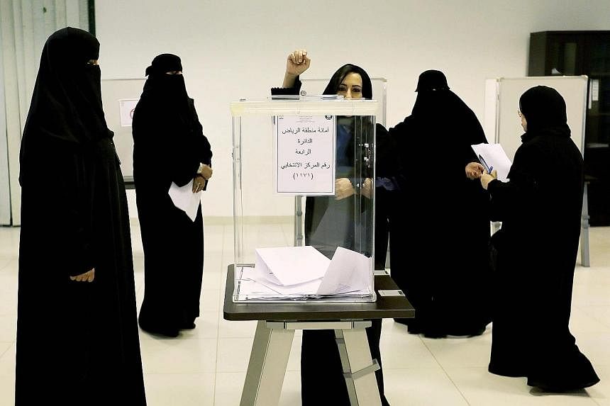 Saudi women voting in municipal council polls, the kingdom's first election open to female voters and candidates, at a polling station in Riyadh on Saturday.
