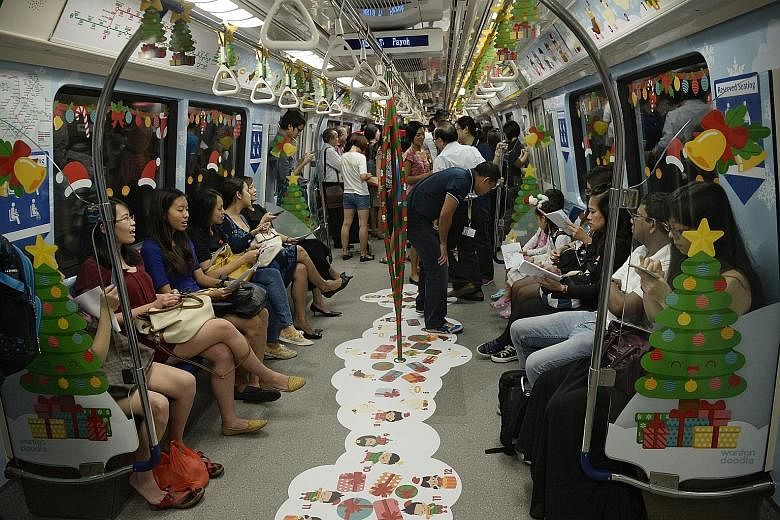A Christmas-themed train on the North-South Line spreading festive cheer to commuters yesterday. The train was launched yesterday and will be deployed on the North-South and East-West lines on different days from now till Dec 27. The train is filled 