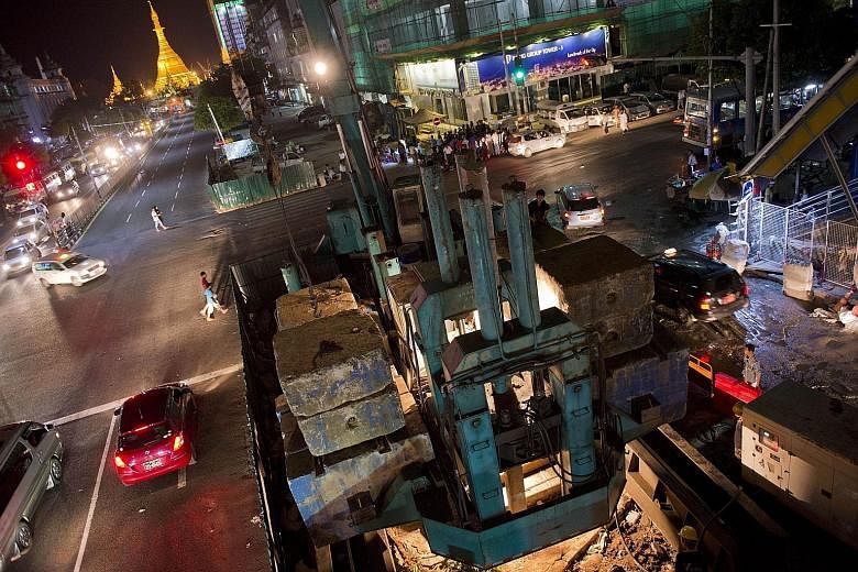 Construction work along Yangon's main road with the Sule Pagoda in the background. Myanmar's banking services are still limited as the economy emerges from isolation.