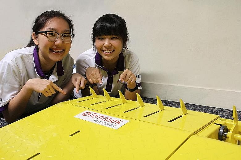Temasek Polytechnic students Ho Ying Jie and Celeste Tan with the Speed Sensitive Spike Ramp. It can be installed onto any surface in five to 10 minutes. Weighing about 20kg, the ramp is portable.