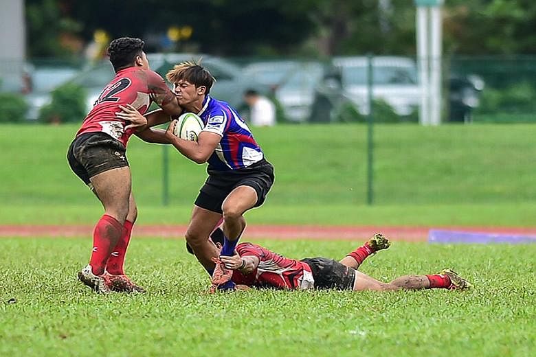 Ahmad Zuhri Idris of Singapore (left) stopping a Chinese Taipei attacker as the Republic lost 16-21 on the second day of the Asian Rugby Under-19 Championship. The hosts saw some chances in the last 10 minutes wasted as they suffered their second def