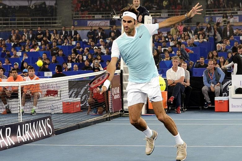 Roger Federer of the UAE Royals hits a backhand volley against Rafael Nadal of the Indian Aces during the International Premier Tennis League (IPTL) encounter in New Delhi, India, on Dec 12. Federer says his perspectives have changed slightly: "If I 