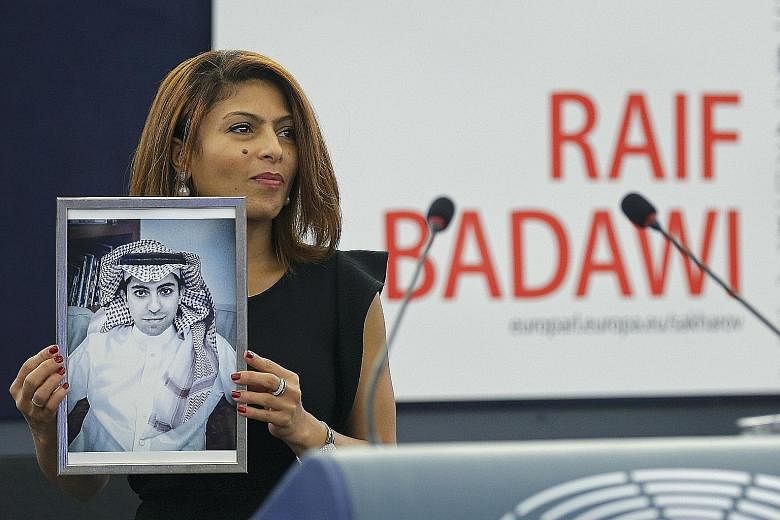 Ms Ensaf Haidar with a portrait of her husband, jailed blogger Raif Badawi.
