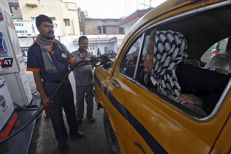 A taxi in India being pumped with diesel fuel. New Delhi's toxic air was ranked worst in the world by a World Health Organisation survey last year.