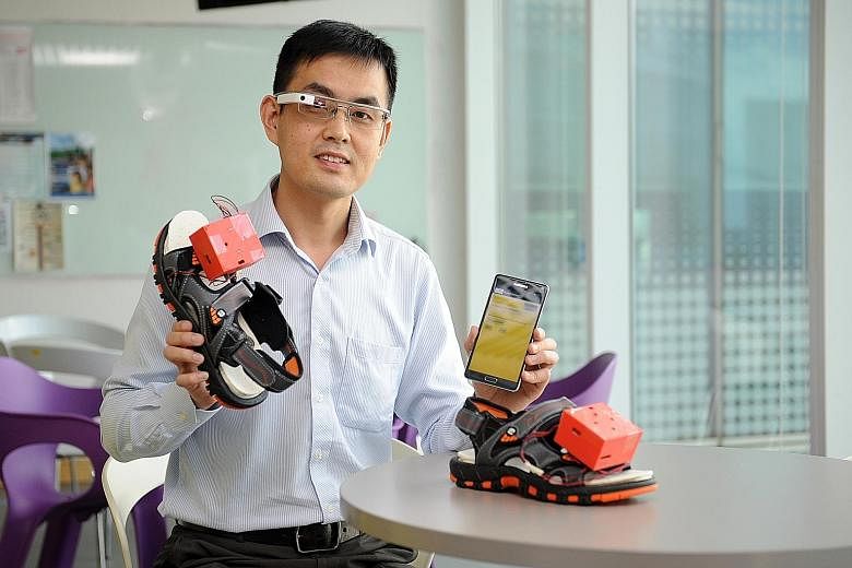 Dr Xu Qianli with the prototype of his wearable navigation assistance for the visually disabled. It comprises a Google Glass device, a mobile phone app and vibrating motors that can be embedded in a user's shoes.