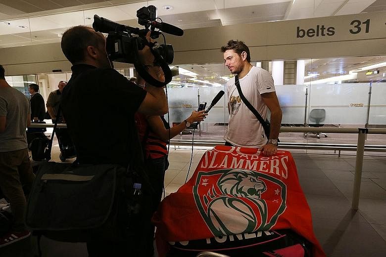 Stan Wawrinka, the headline act for the Singapore Slammers, on arrival in Singapore yesterday. He hopes his clash with Roger Federer will be "a good show for the crowds".