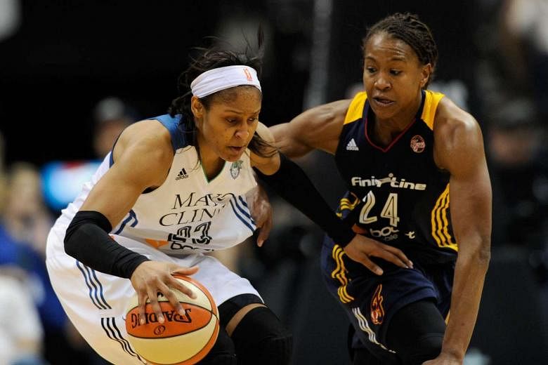 Tamika Catchings (far right) of the Indiana Fever defends against Maya Moore of the Minnesota Lynx in Game Five of the 2015 WNBA Finals on Oct 14. The Lynx defeated the Fever 69-52 to win the WNBA Championship.