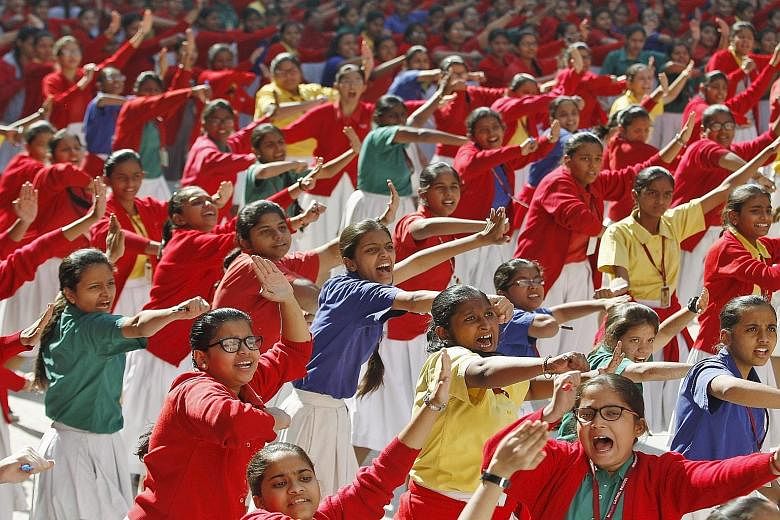 Schoolgirls practising martial arts during an event in Ahmedabad, India, on Wednesday to mark the third anniversary of the fatal gang rape of a woman on a Delhi bus in December 2012.