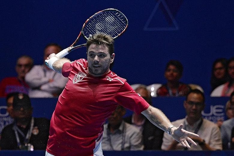 Stan Wawrinka in action against Roger Federer during the opening day of the International Premier Tennis League in Singapore.