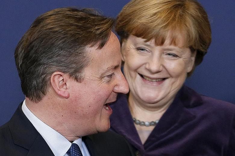 Mr David Cameron with Germany's Chancellor Angela Merkel during the EU leaders summit in Brussels on Thursday. The British PM left the negotiations with an optimistic message about the prospects for a deal at the next European summit in February.