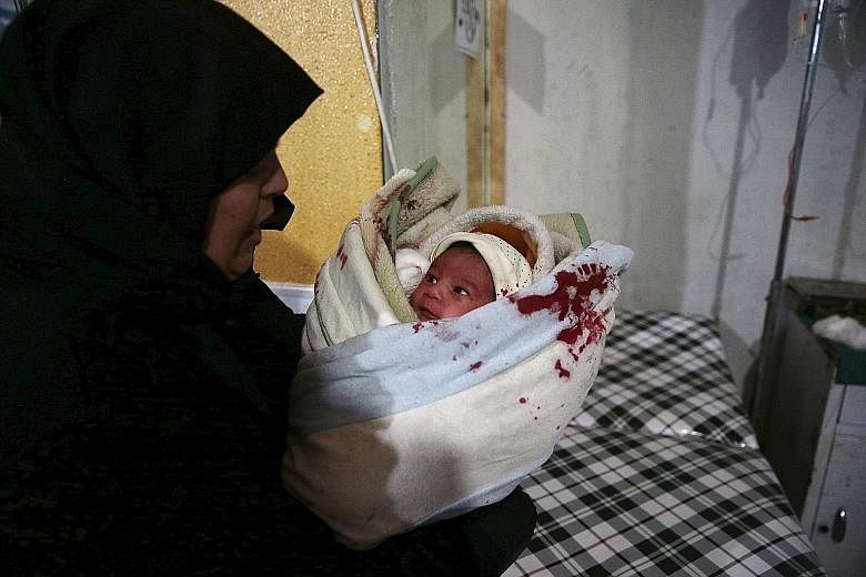 An injured baby inside a field hospital after what activists said were missile and air strikes in the Douma area of Damascus last Sunday.