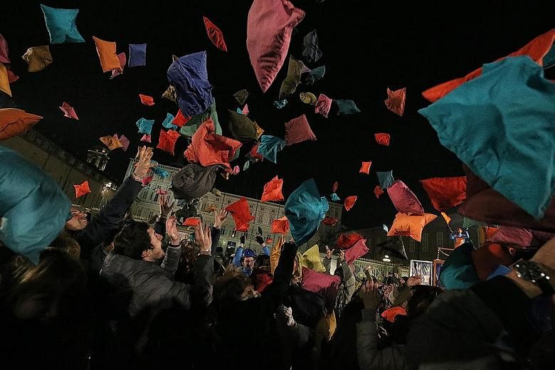 Laughter filled the night as people threw pillows into the air, as part of "Pillow Fight", an event organised by Italian theatre company Il Melarancio in Piazza Castello in Turin on Friday. More than 700 colourful pillows were brought to the piazza f