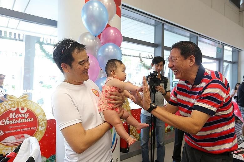 DPM Teo meeting a couple of participants at yesterday's family carnival.