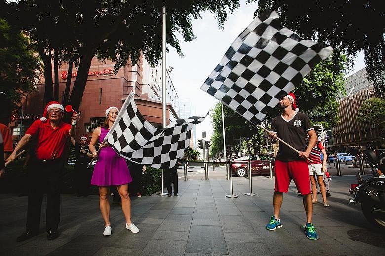 Australian tennis player Jarmila Gajdosova (left) and Goran Ivanisevic, the 2001 Wimbledon champion from Croatia, flagging off a convoy at Orchard Road yesterday, sending the Harley-Davidsons and Chrysler Jeeps on their way to deliver Christmas prese