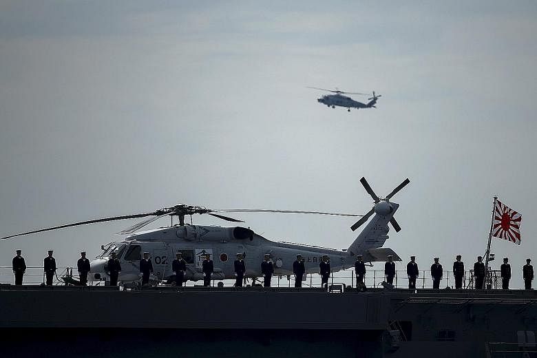 Military personnel on the Izumo helicopter carrier. Prime Minister Shinzo Abe in September pushed through legislation allowing Japanese troops to fight abroad for the first time since World War II.