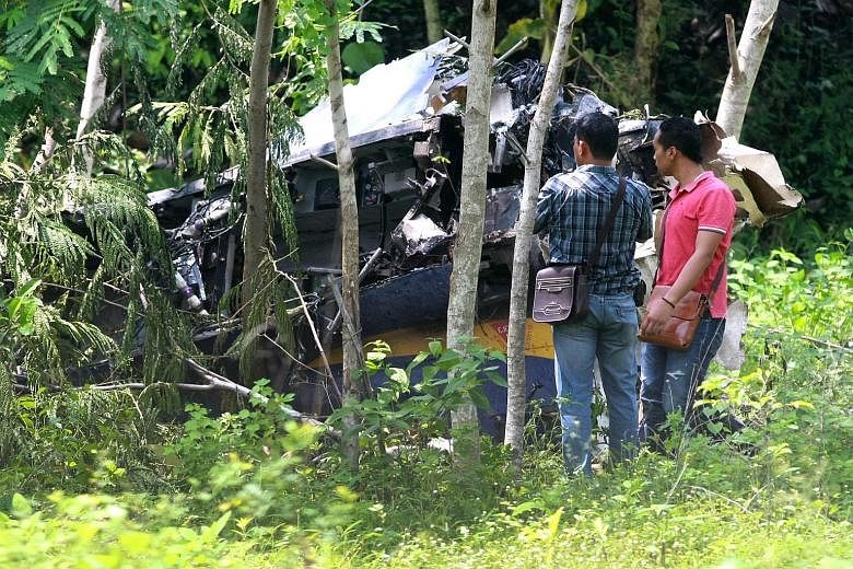 Soldiers in plain clothes checking the wreckage of the South Korean-made T-50 Golden Eagle jet after it crashed while performing at an air show in Yogyakarta yesterday.