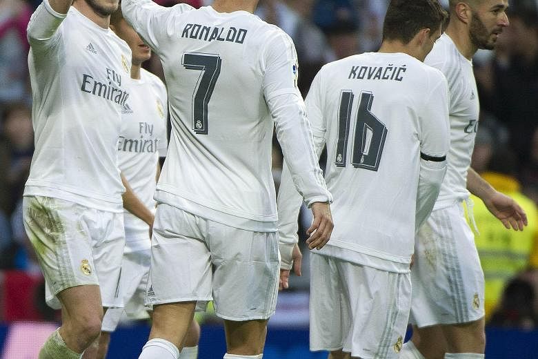 Gareth Bale (left) celebrating with Ronaldo and their Real Madrid team-mates after scoring against Rayo Vallecano. It is the first time the Welshman netted four times in a match in his three-year Madrid career.