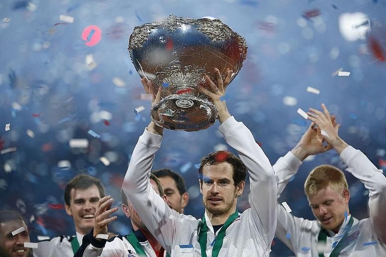 Britain's Andy Murray celebrating with the Davis Cup trophy. The world No. 2 had also helped the Singapore Slammers win the IPTL title.