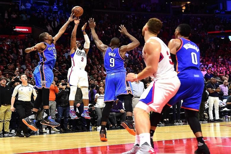 Chris Paul (No. 3) of the Los Angeles Clippers having his last-second shot blocked by Kevin Durant (left) of the Oklahoma City Thunder, resulting in a narrow 100-99 Thunder victory. The Thunder have now won eight of their past nine games, while the C