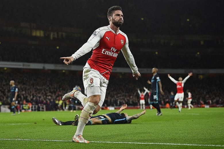 Olivier Giroud celebrating after scoring the second goal for Arsenal in their 2-1 win over Manchester City. The Gunners have won their fourth straight game in all competitions and are in second place in the league, two points behind leaders Leicester