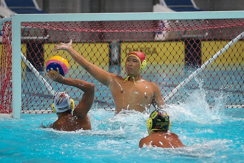 Singapore water polo club Pacer's goalkeeper Fong Wai Chun attempts to block a shot by Rohan Lee of Malaysian side Kinta. Pacer won 14-12 to claim the Under-16 category in the second edition of the Singapore Water Polo Junior Inter-Club Invitational 