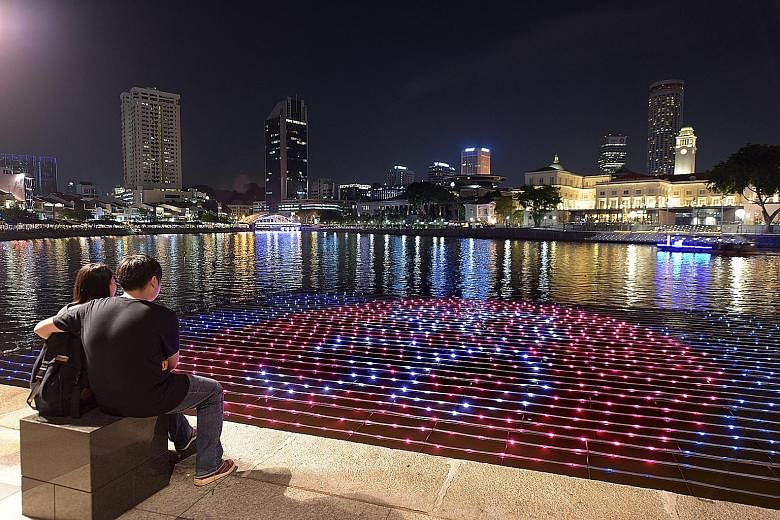 The Singapore River is lit up by a new floating art installation, which visitors can interact with using their mobile devices. The display - shaped like a map of Singapore - makes use of more than 2,000 LED lights. Visitors can send New Year wishes v
