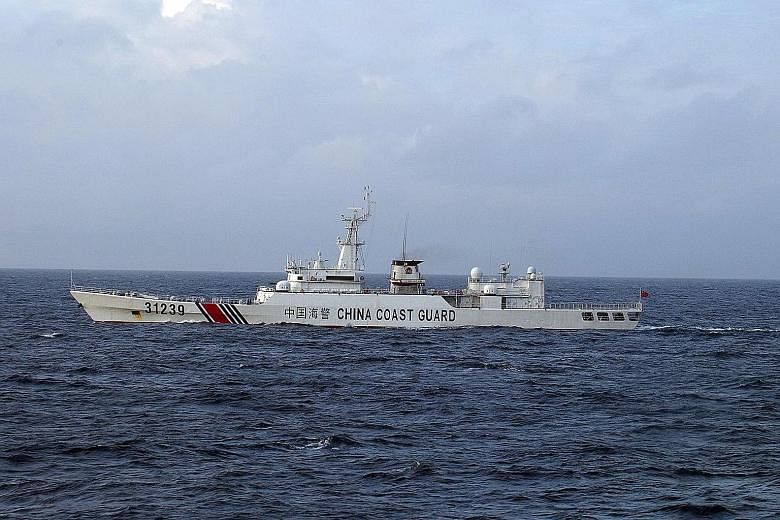 A Chinese coast guard ship armed with "cannon-like" weapons near disputed islets in a photograph released by Japan yesterday.