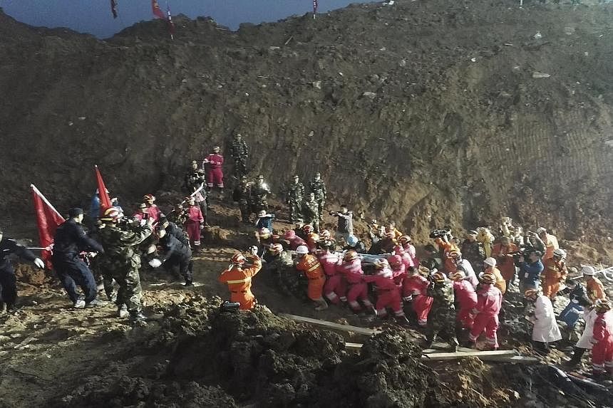 Rescuers carrying the survivor away from the site of the tragedy. Though his right leg was pinned down by debris, he survived for 67 hours on pomelo and melon seeds that he found, according to Chinese media reports. Doctors said he was in a stable co