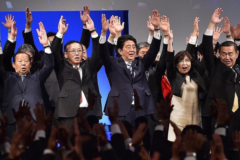 Prime Minister Shinzo Abe (centre) cheering with Liberal Democratic Party members at a ceremony to mark the 60th anniversary of the party's founding on Nov 29 in Tokyo.
