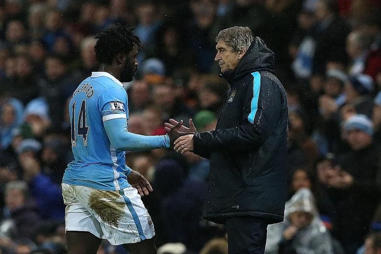 Manchester City's manager Manuel Pellegrini (left) greeting Wilfried Bony after the striker scored against Swansea. But the Ivory Coast international was dropped for the next match against Arsenal.