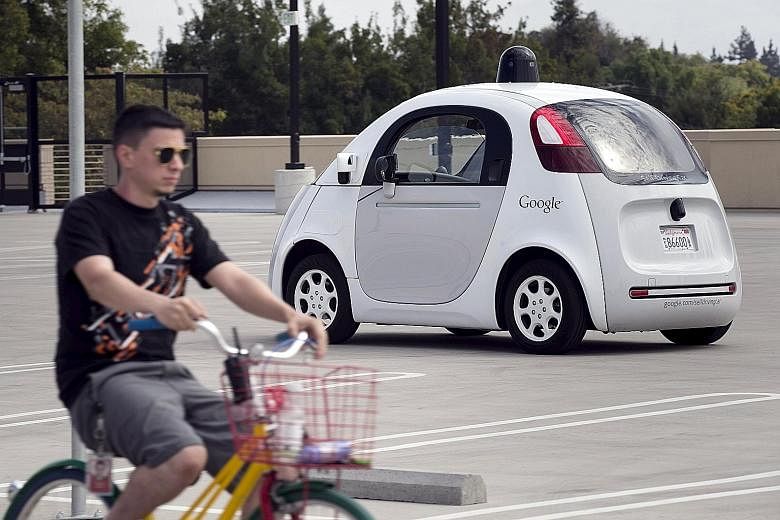 A Google employee on a bicycle acting as a real-life obstacle for a Google self-driving car to react to, during a media preview of the Internet giant's prototype autonomous vehicles in Mountain View, California, in September. Google has logged more t