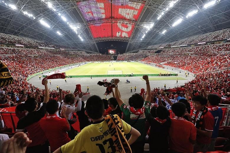 Fans celebrate as Singapore score the equaliser against Thailand in the AFF Suzuki Cup in November 2014. The now-rescheduled Merlion Cup was originally slated to be played at the National Stadium as well, in hopes of rallying the football community t