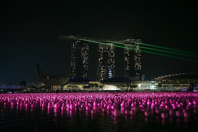 Among the highlights of the Marina Bay Singapore Countdown to usher in the new year are 20,000 wishing spheres (above) and the grand finale of an eight-minute fireworks display that will stretch across the length of Marina Bay. Police will be taking 
