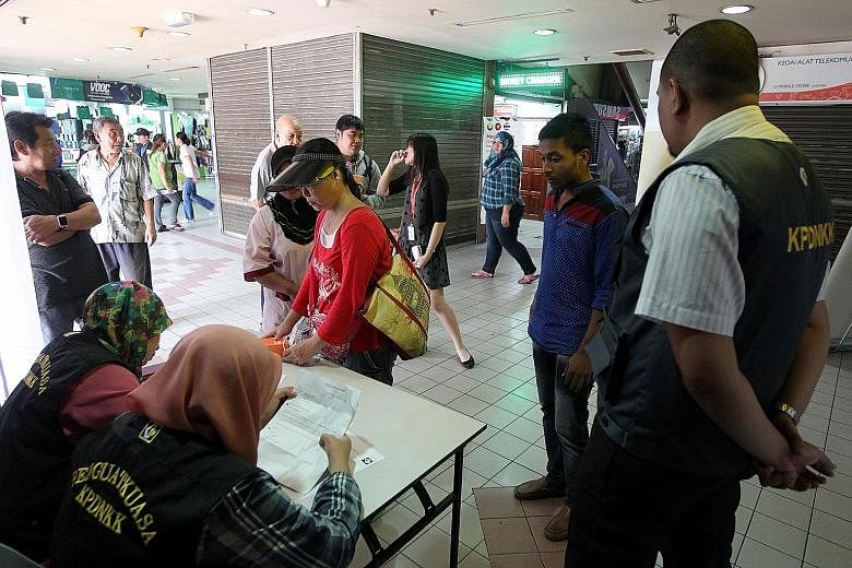 Domestic Trade Ministry officials taking down complaints from customers who were allegedly cheated at Kota Raya mall.
