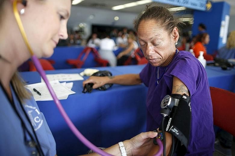 Ms Valerie Caesar, 46, having her blood pressure taken in October at the Care Harbor four-day free clinic, which offers free medical, dental and vision care to around 4,000 uninsured people in Los Angeles, California.