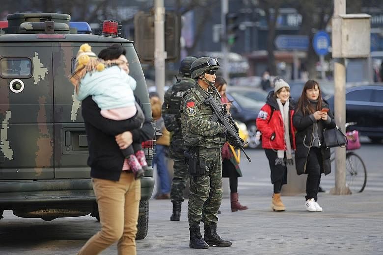Members of a commando unit standing guard yesterday in Sanlitun, a shopping and dining area in Beijing. The US embassy in the Chinese capital says it has received information of possible threats against Westerners on or around Christmas Day in Sanlit