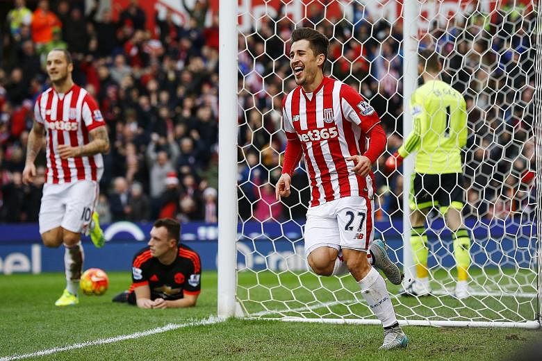 Above: The anguish of Manchester United manager Louis van Gaal is laid bare as his men fail to contain the Potters. Left: Bojan Krkic (No. 27) celebrating after scoring the first goal in Stoke City's 2-0 Premier League victory over United at Britanni