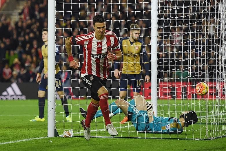 Southampton's Jose Fonte celebrating after scoring his side's third goal in the stunning 4-0 win against Arsenal on Boxing Day. Despite Arsenal failing to take top spot in the Premier League, Arsene Wenger rejected former England boss Glenn Hoddle's 