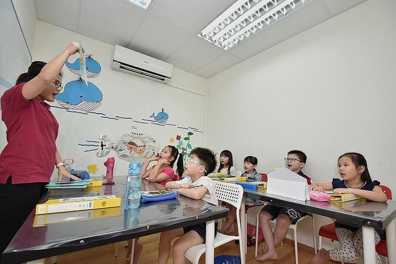 Sprightly Learning Campus co-founder Jolyn Low uses flash cards during a maths lesson for six-year-olds (from left) Leow Hui Yu, Cayern Se, Alecia Tan, Koay Ger Maine, Isaac Lim and Isabell Tan.