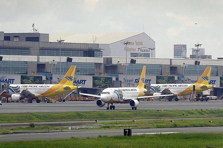 Planes at Manila's Ninoy Aquino International Airport. The Philippines has removed restrictions from all cities except its capital Manila, while Indonesia has opened up only Jakarta. The other eight Asean countries, including Singapore, have lifted a