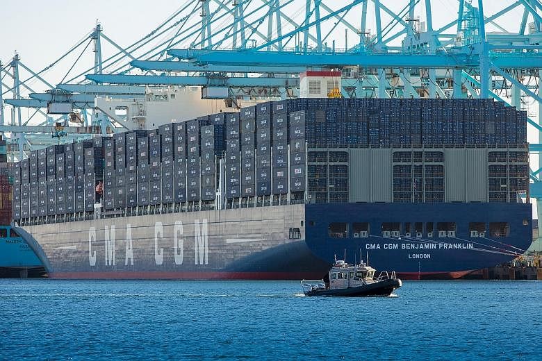 The Benjamin Franklin, operated by French container company CMA CGM, sits docked at the Port of Los Angeles in California on Saturday. It is the largest container vessel to call at a United States port. It is longer than the Empire State Building lai