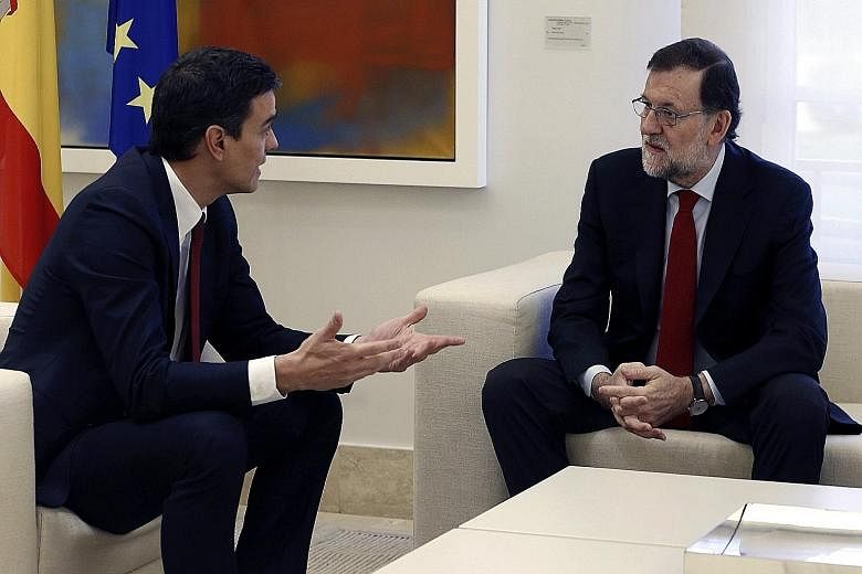 Prime Minister Mariano Rajoy (right) meeting Socialist leader Pedro Sanchez at the Palace of La Moncloa in Madrid last Wednesday to discuss the situation after the Dec 20 election. Mr Rajoy hopes to form a coalition government after his Popular Party