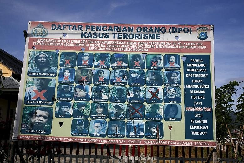 An Indonesian police billboard on Dec 19 showing a list of militants, including Indonesia's most wanted man Santoso (top left). Complaints against intolerant views spread on air have risen, with local television stations being the biggest target of n