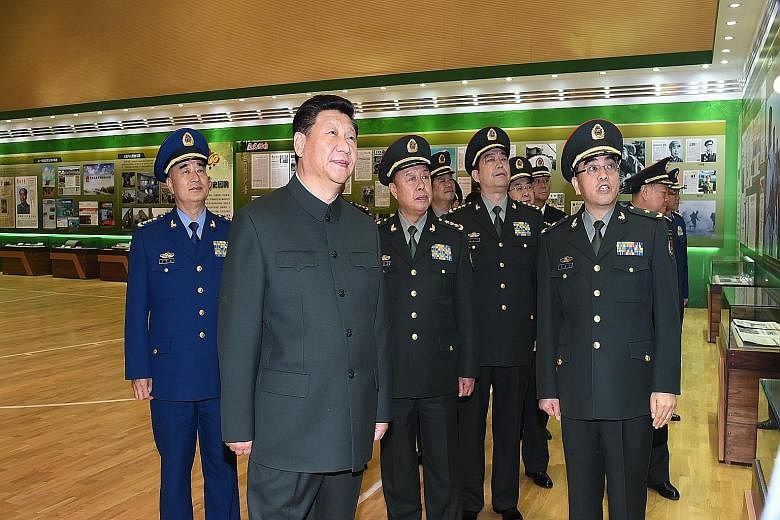 President Xi (second from left) visiting the PLA Daily's headquarters last Friday to commemorate the paper's 60th anniversary. Mr Xi called on the paper to play a leading role in strengthening the military during his visit.