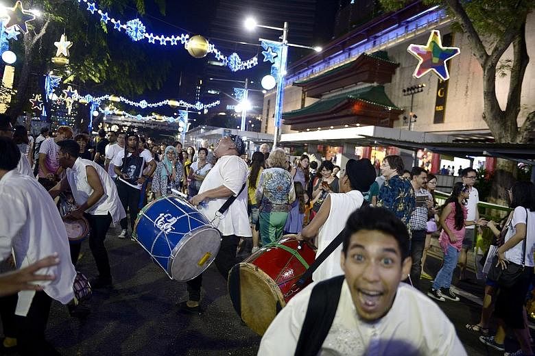 Visitors taking in a street performance on Pedestrian Night in Orchard Road in January. The upcoming event this Saturday will feature drummer Brandon Khoo and a cappella group MICappella, among other performances.