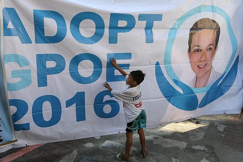 A banner on display in front of the Supreme Court during a demonstration yesterday against the move to disqualify Ms Poe from running in the 2016 elections.