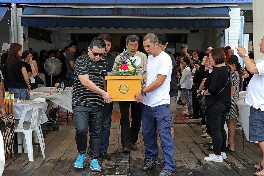 The coffin (left) of six-year-old Rayshon Lim (above) being carried out of the funeral parlour in Sin Ming Drive yesterday. Rayshon was travelling with his parents Barnabas Lim and Kristen Ng (both above) in Malaysia when they were killed in a car cr