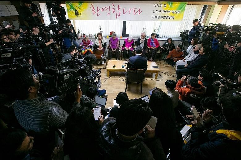 South Korean Second Vice-Foreign Minister Cho Tae Yul (sitting with back to camera) meeting former comfort women at a shelter in Seoul yesterday.
