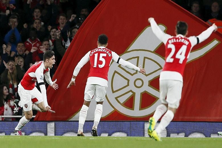 Arsenal's Gabriel Paulista (left) celebrating with team-mates Alex Oxlade-Chamberlain and Hector Bellerin after scoring the first goal against Bournemouth.